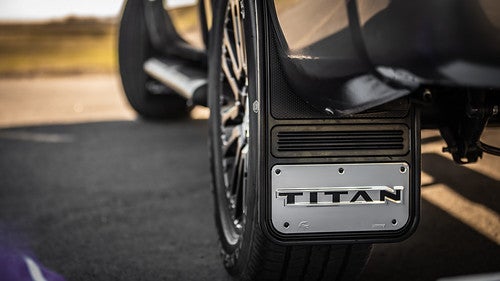 Close on rear left of 2021 Nissan Titan with Titan logo on tire flap