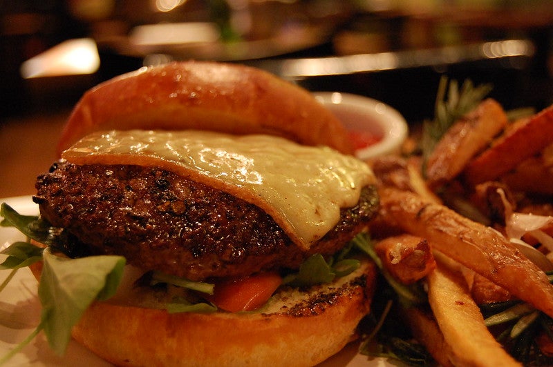 A plate of burgers and fries at a restaurant