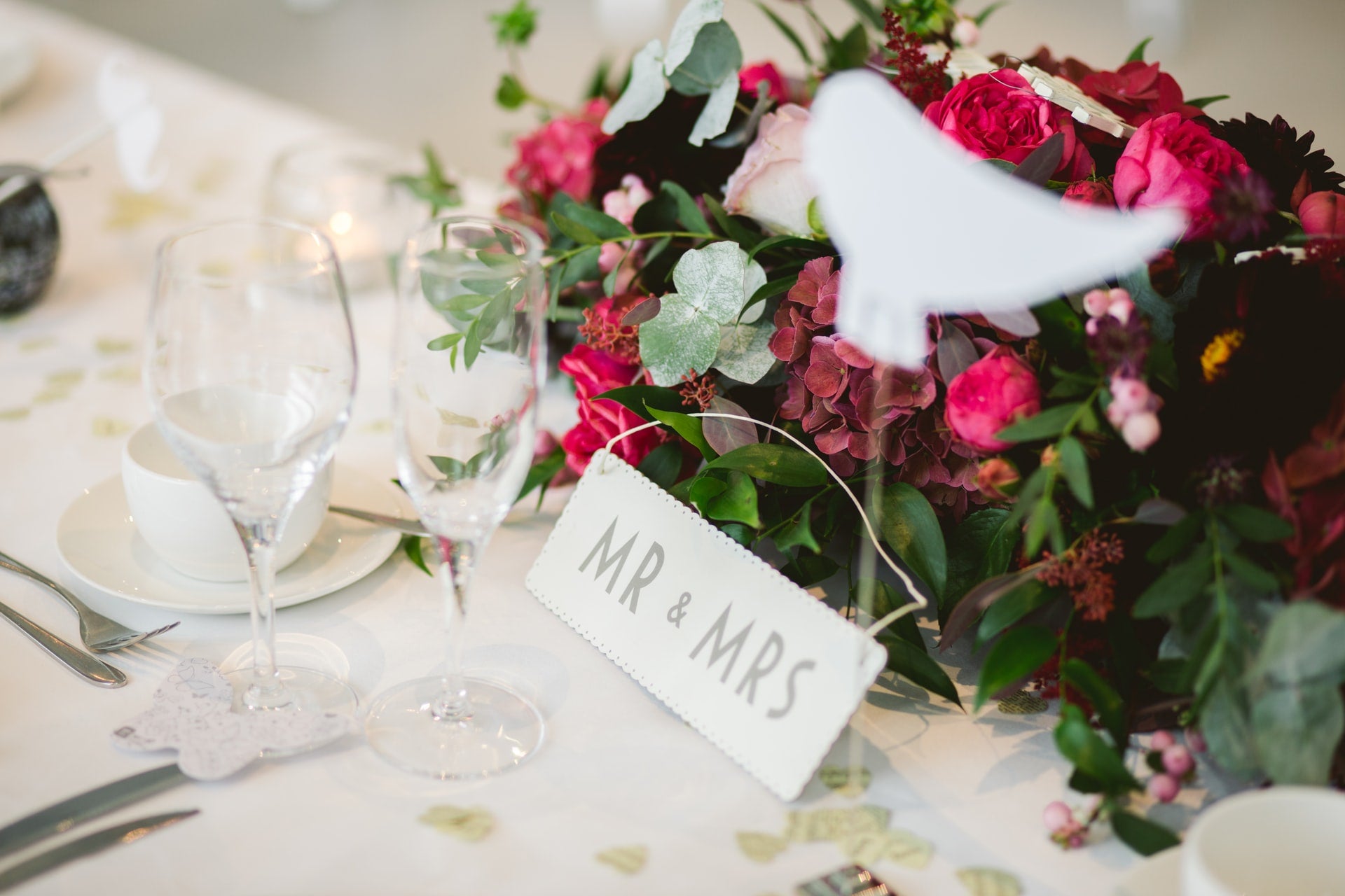 Mr. & Mrs. table setting for wedding with floral display