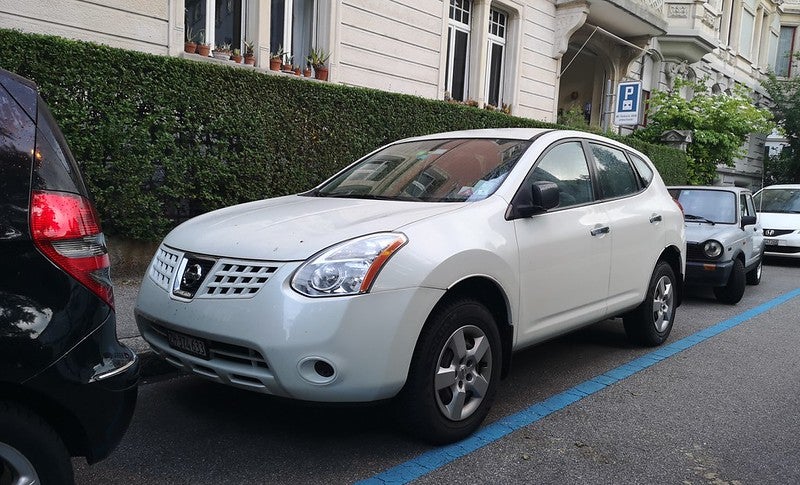 White Nissan Rogue parked on street
