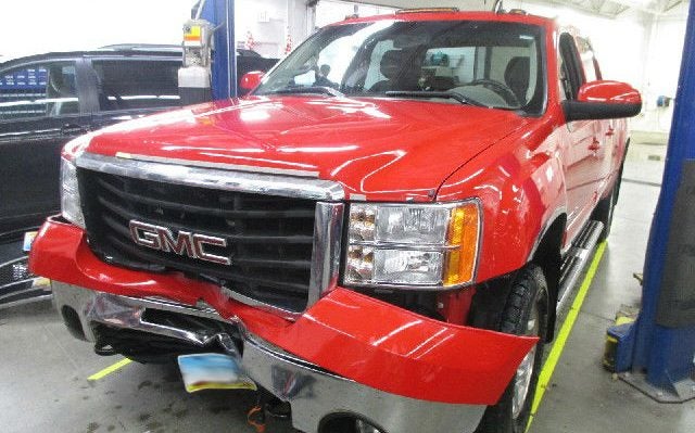Rydell GMC Truck with the front bumper hanging off.