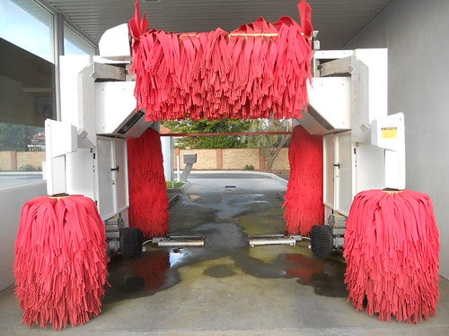 Red tunnel car wash brushes