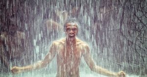 A guy standing underneath a waterfall while swimming | Goldstein Chrysler Jeep Dodge RAM