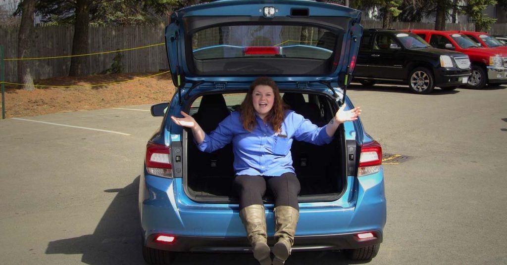 Amber sits in the back of the Subaru Impreza Sport