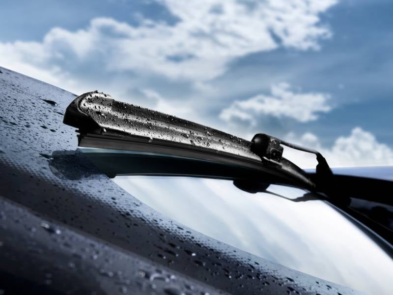 close up image of a windshield wiper covered in rain