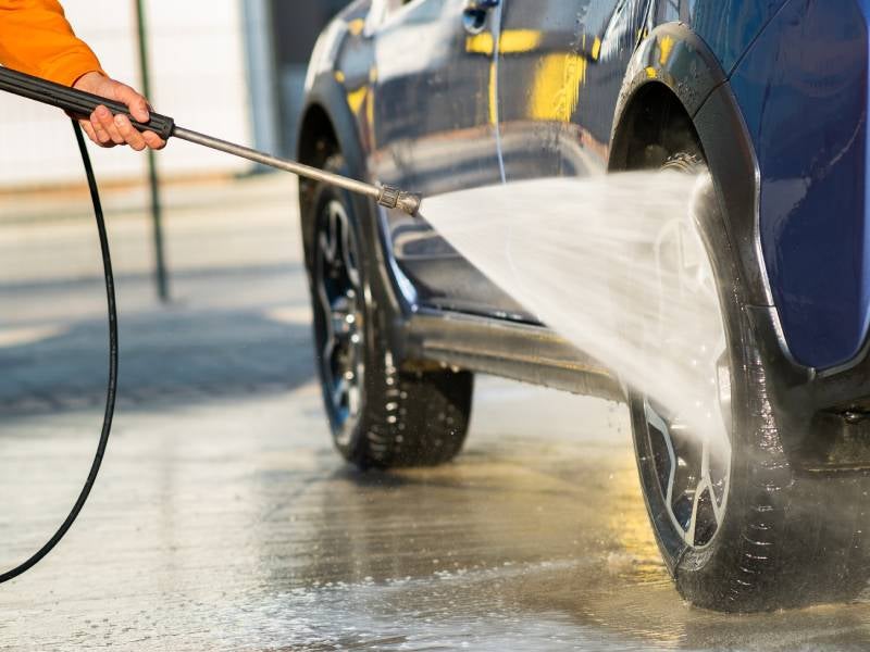 close up of a tire being powerwashed
