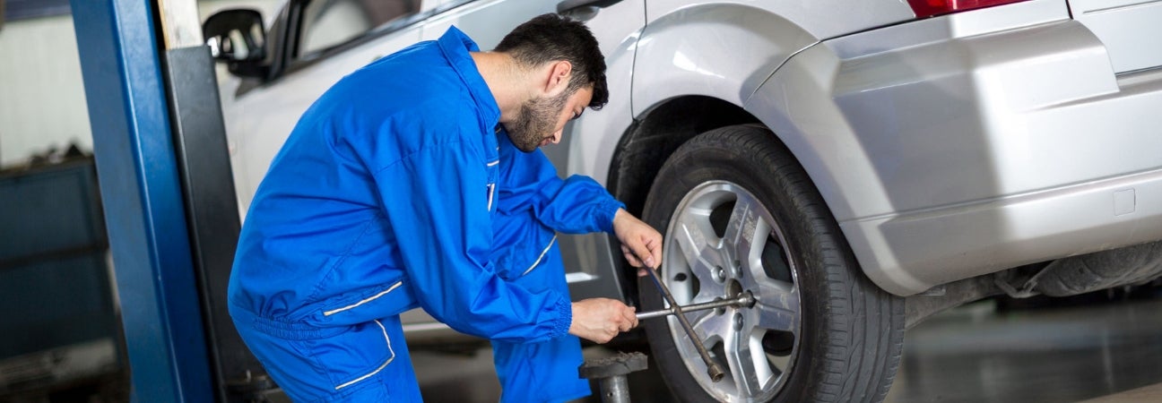 Service technician performing tire rotation