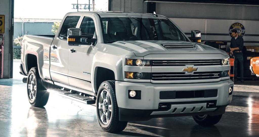 A white Chevy Silverado 1500 Custom Sport HD parked in a garage