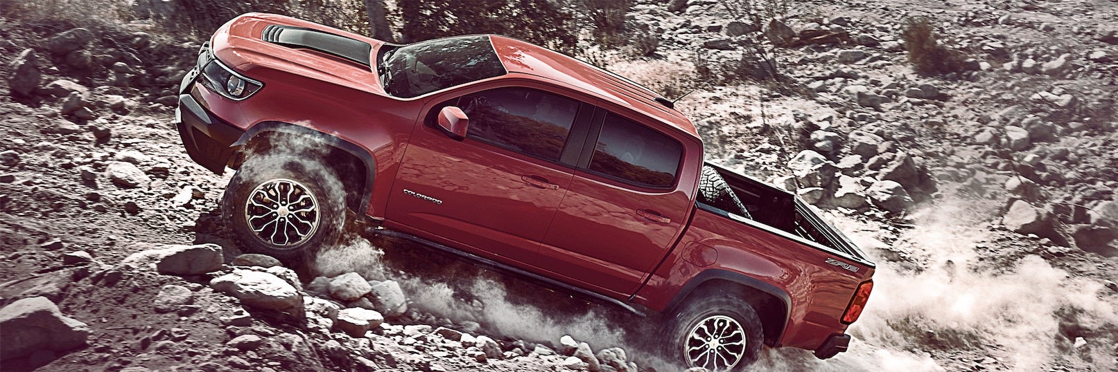 A red 2017 Chevy Colorado ZR2 driving off road.