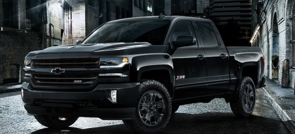 A black Chevy Silverado 1500 Midnight on the street at night