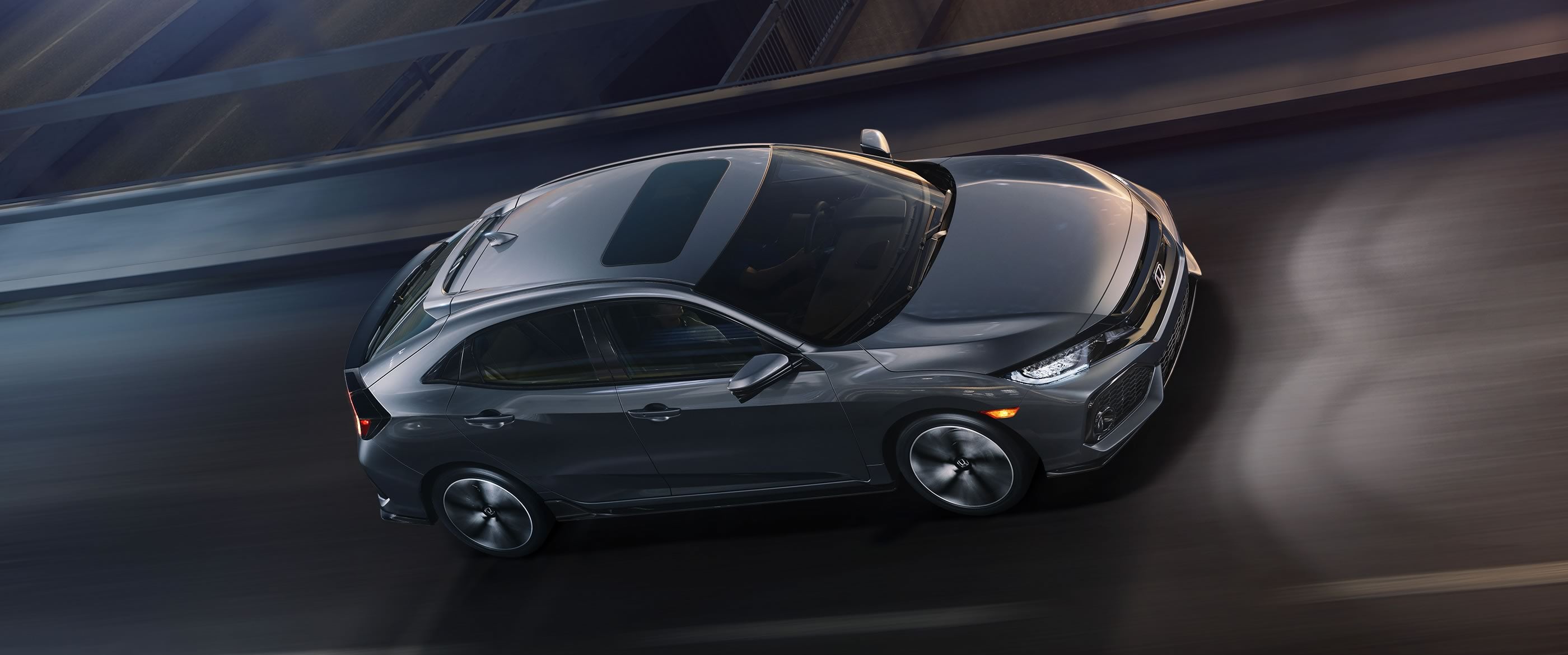 2017-civic-hatch-sport-touring-ext-nh-877-profile-driving-night-1400-2x