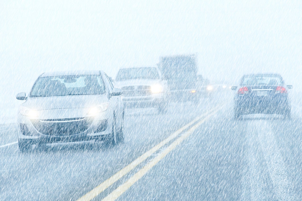 Cars Driving in Snowstorm