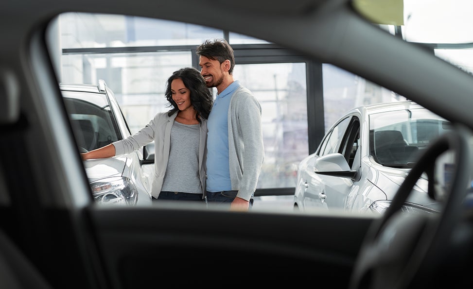 Bennett Toyota of Allentown is a Car Dealership near Westwood Heights PA in Allentown | Couple Looking at New Car Inventory in Dealership Showroom