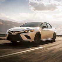 Model Features of the 2022 Toyota Camry at Bennett Toyota | Camry driving fast as sun sets