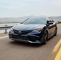 Model Features of the 2022 Toyota Camry at Bennett Toyota | Drive by shot of Camry's front