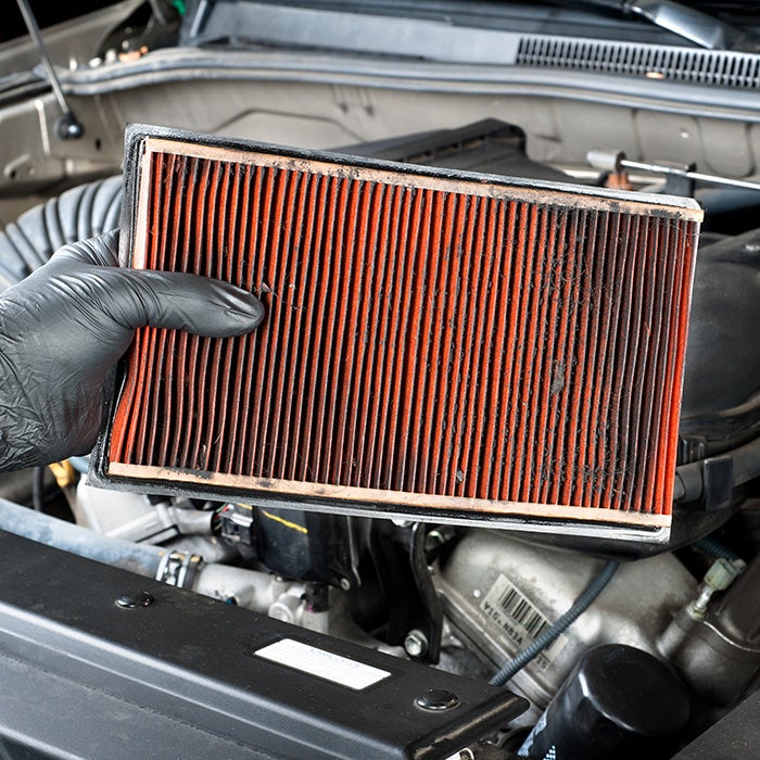 Tips for spring cleaning your car at Bennett Toyota of Allentown | Service Advisor Holding Up Dirty Engine Air Filter