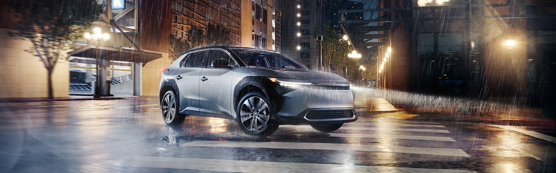 The All-New Toyota Electric Car: The Toyota bZ4X BEV at Bennett Toyota of Allentown | Silver bZ4X BEV Driving Through Pouring Rain In City Streets at Night