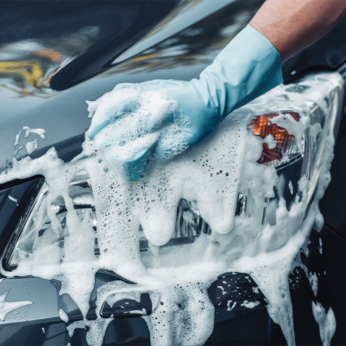 Tips for spring cleaning your car at Bennett Toyota of Allentown | Sudsy Soap Being Scrubbed Onto Headlight