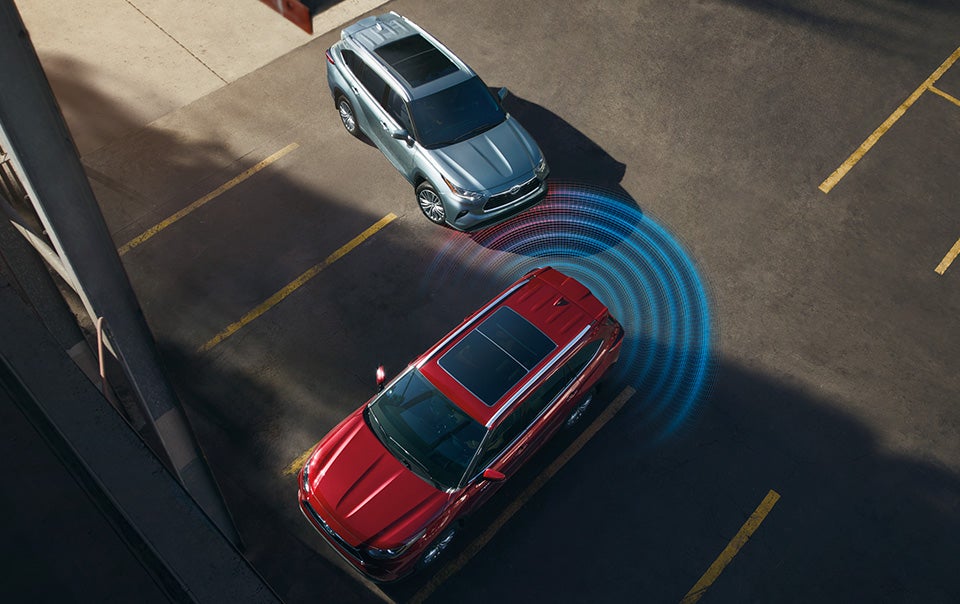 Model Features of the 2022 Toyota Highlander Hybrid at Bennett Toyota | Red and Blue Highlander Hybrid Demonstrating How Toyota Safety Sense Works