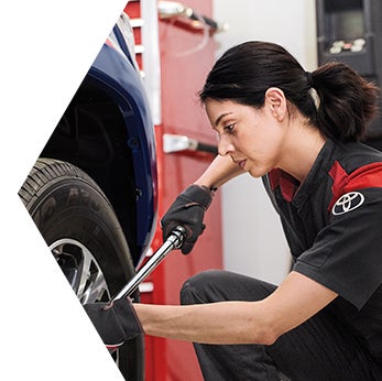 Basic Car Maintenance and Servicing Checklist | Toyota Mechanic tightens tire lug nuts