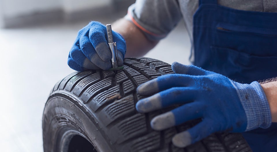 What is a Tire Rotation? at Bennett Toyota of Allentown | Service Advisor Measuring Tread on Tire