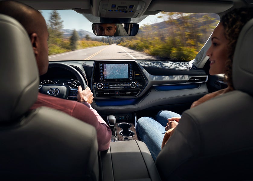 The 2022 Toyota Highlander vs. The 2021 Toyota Highlander at Bennett Toyota | Couple Driving Around in 2022 Toyota Highlander - GPS is on Screen of Infotainment System