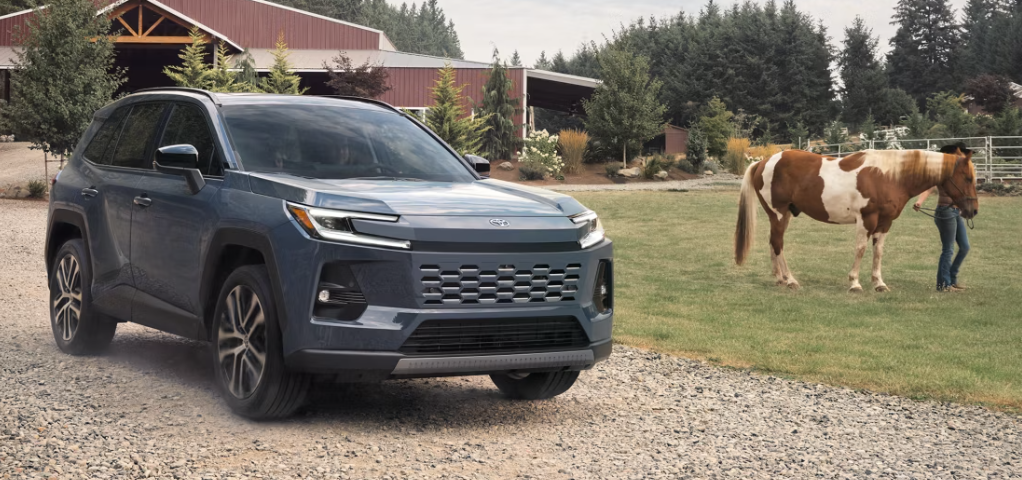 2026 Toyota RAV4 on a gravel road near a ranch
