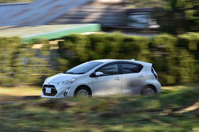 white toyota sedan driving on road