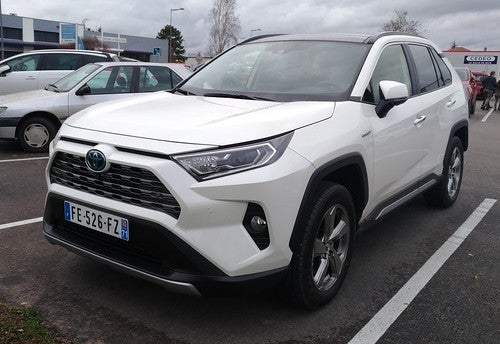 a white toyota rav4 is parked