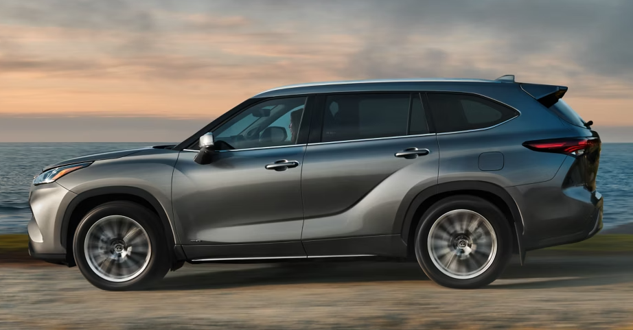 Highlander Hybrid driving along lake